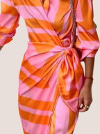 Summer midi dress with geometric pattern, close-up of wrap detail