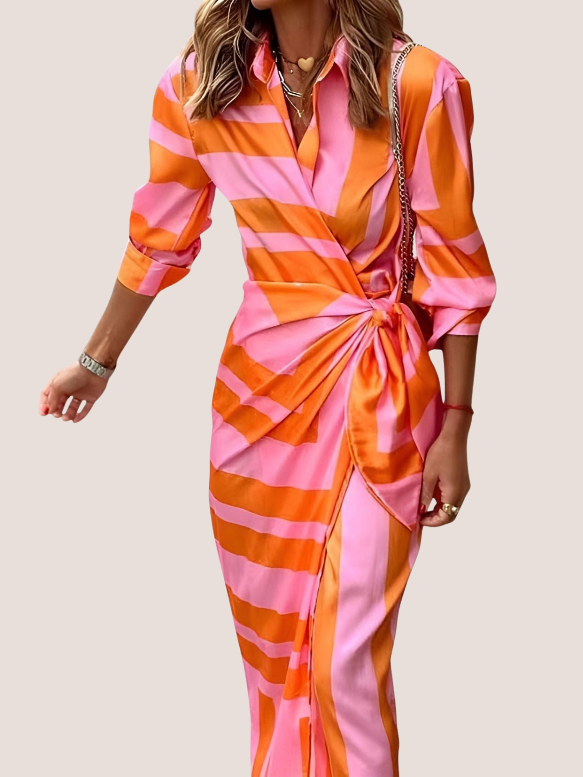 Summer midi dress with geometric pattern, close-up of pink and orange pattern detail
