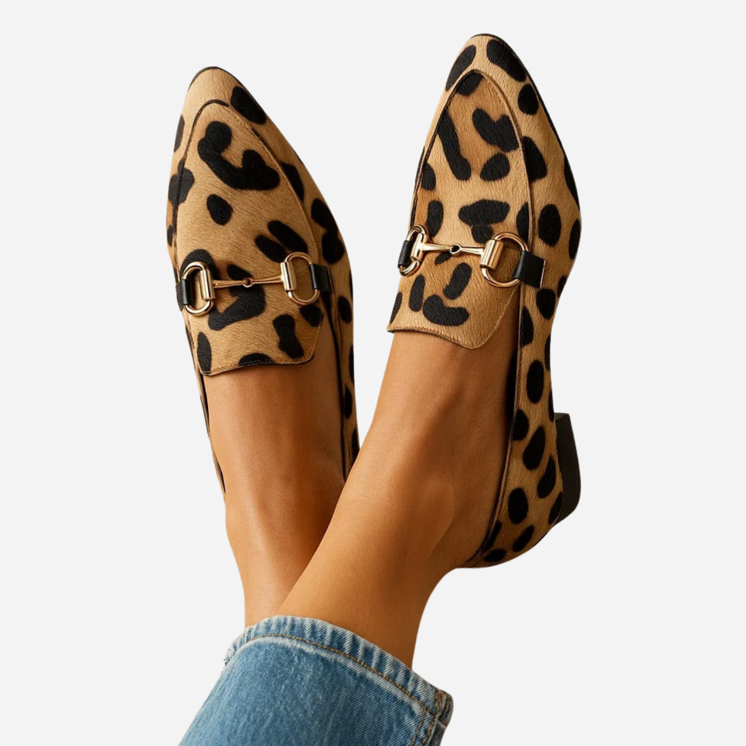 Women's leopard print loafers with gold horsebit buckle, worn with jeans, top-down view